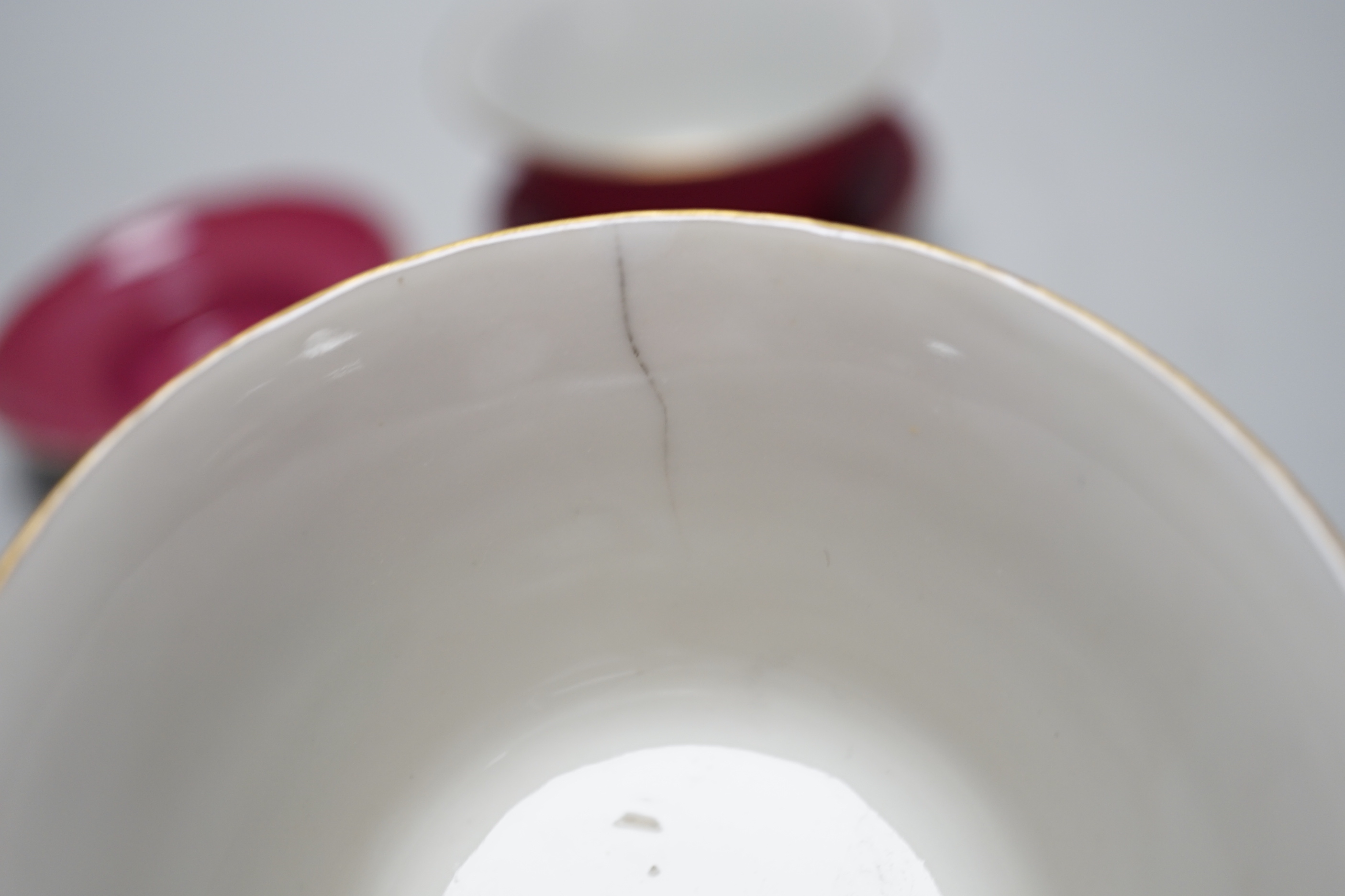 A pair of Chinese ruby ground tea bowls, covers and stands
